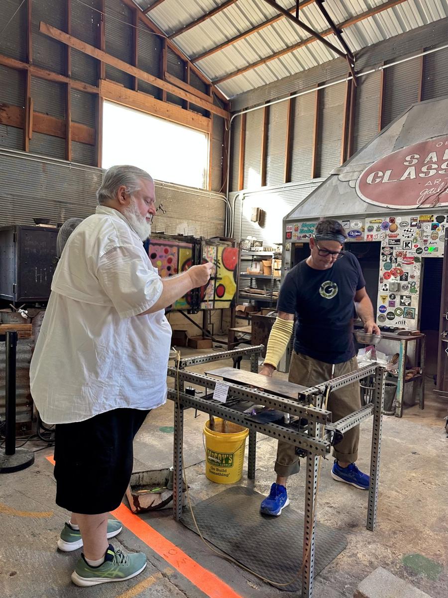 🔥 Inside Salado Glassworks: a gallery with glass hanging from every rafter, then Billy at the bench getting his instructions. Brandy also ca